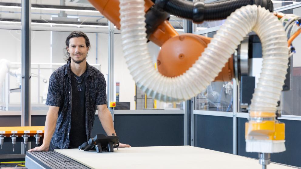 Colleague in an industrial setting featuring an articulated robotic arm