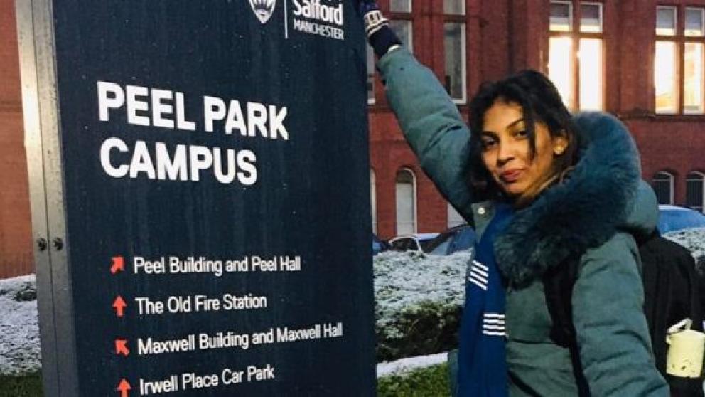 Saranga next to a Peel Park Campus directional sign, University of Salford