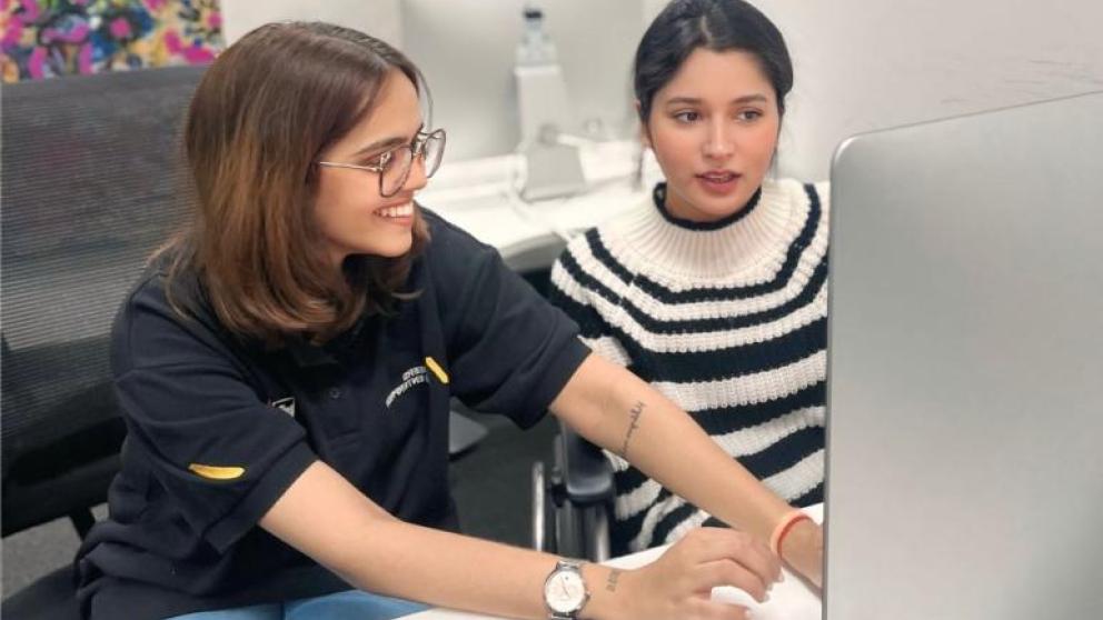 Two students working on a computer