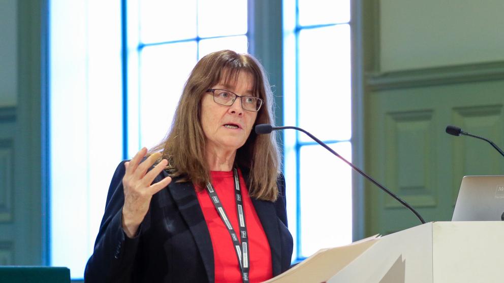Professor Helen Marshall OBE speaking at a podium