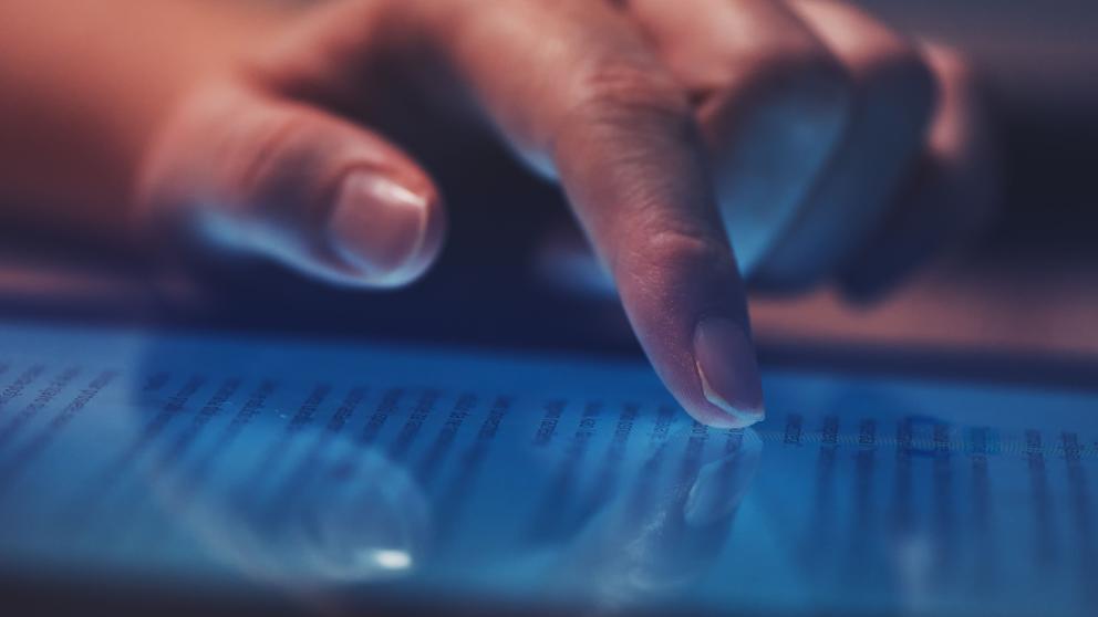 A female hand scrolls a phone screen