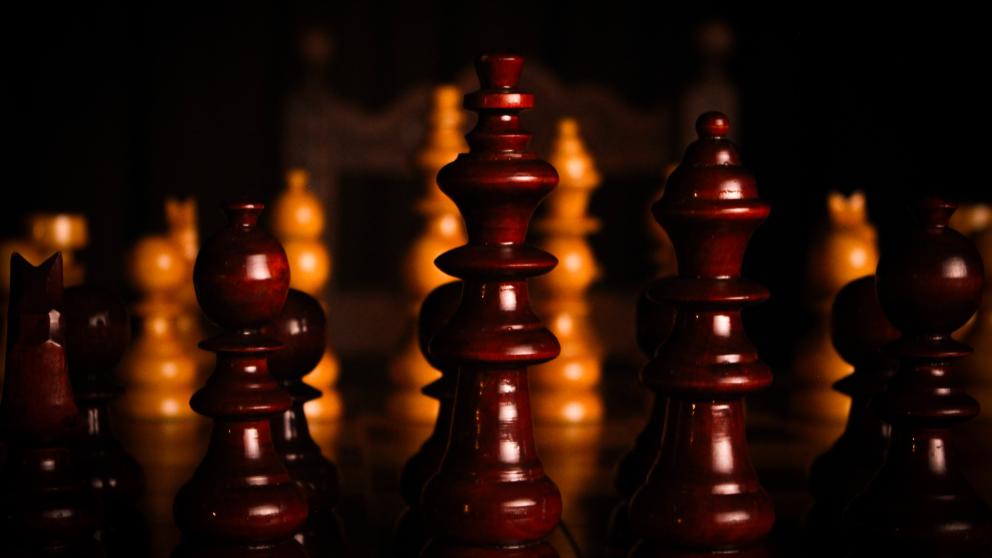 Chess pieces lit by film cameras