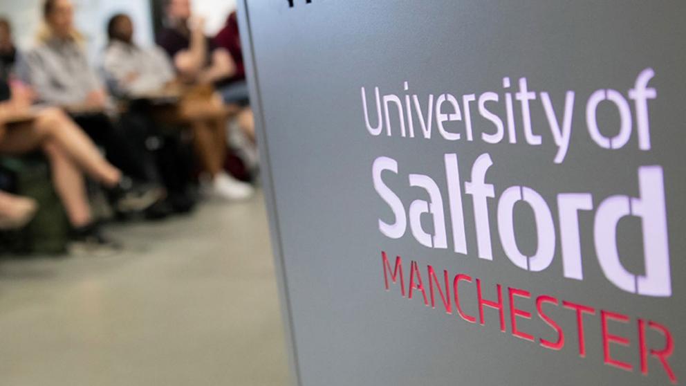 University podium in the foreground with a lecture of students in the background