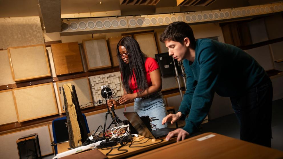 Acoustics students using equipment