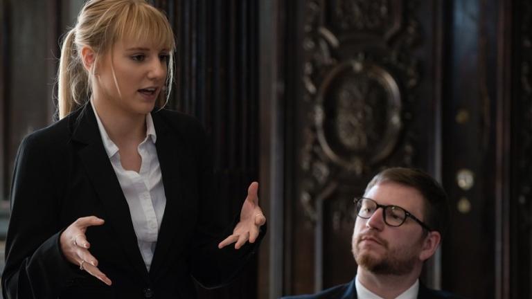 Two law students in a courtroom