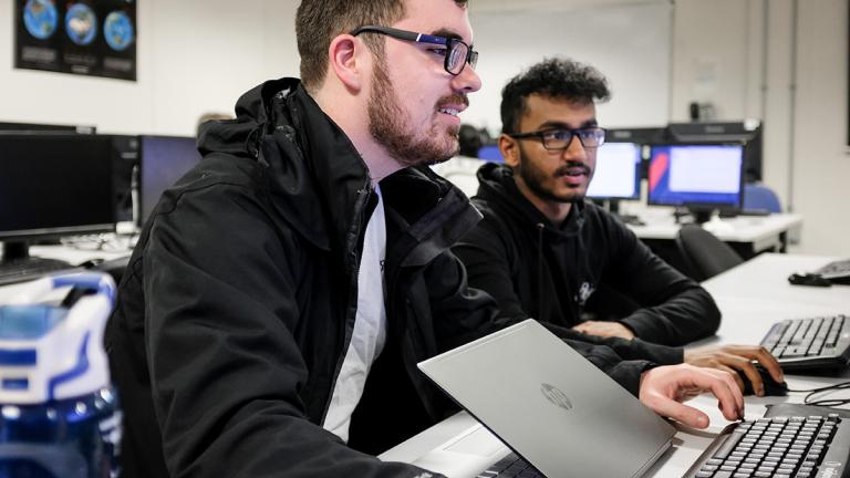 Two students working together at computers