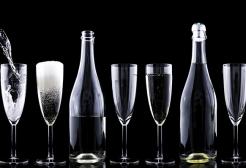 Bottle pouring champagne into glasses