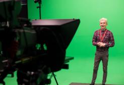 A camera filming a student against a green screen at MediaCity