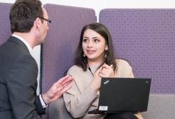 Dr Chris Doran speak to a postgraduate student