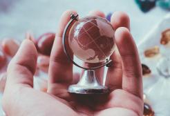Hand holding a miniature globe