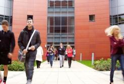 Multiple people outside the entrance to the Mary Seacole Building, University of Salford