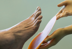 Image of podiatrist's hand near foot 