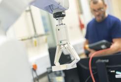 Engineer operating a robotic arm