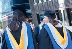 Graduands wearing gowns and mortar boards