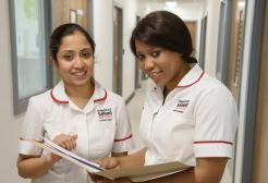 Student nurses reading patient records