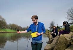 Student working in a river on a field trip