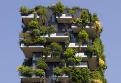Tall building growing plants and greenery on the exterior