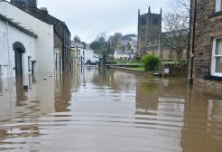 Flooded street with church building in the background
