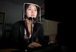 Psychology student looking into a screen with chin on a rest