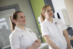 Two physiotherapy students watching a demonstration 