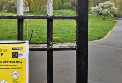  Salford City Council COVID-19 safety notice posted on a metal park gate during the pandemic
