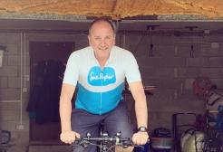 Dr Tony Gill sat on his cycle