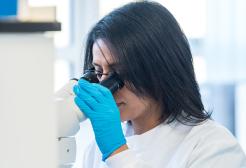 A science student looking into a microscope