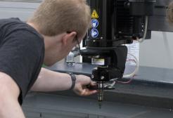 	Students working with the water jet cutter the Morson Maker Space, University of Salford
