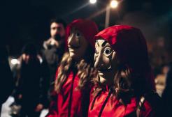 Two actors wear costumes