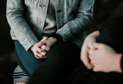 Two people hold a discussion