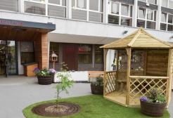 Wooden pagoda and garden in courtyard outside the Dementia Hub entrance