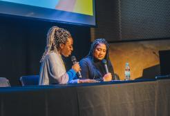 Two people speaking at the Black Impact panel discussion