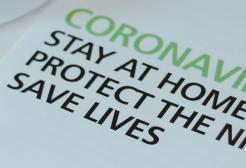 An official UK Government and NHS coronavirus information leaflet with the slogan "Stay at home, protect the NHS, save lives"