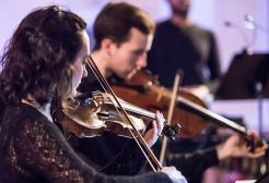 Two people playing the violin