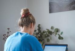 A person works at a laptop