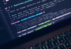 A laptop computer screen displaying programming code