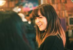 Seren Hughes smiling at a colleague 