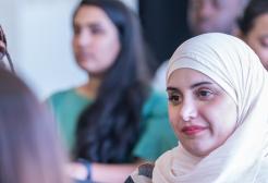 A diverse group of attentive students listening during an academic lecture