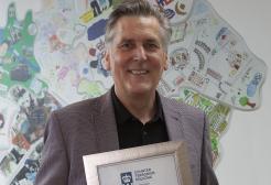 Andrew Hartley receives his award at Greater Manchester Police headquarters