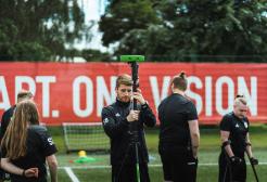 Dan Towers portrait, Blackburn Rovers coach setting up football pitch equipment