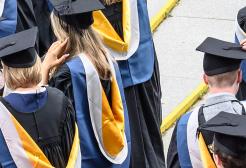 Graduands wearing gowns and mortar boards 