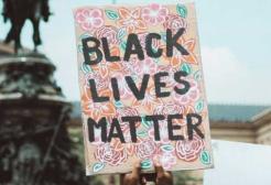 A protestor holds a placard bearing the Black Lives Matter slogan