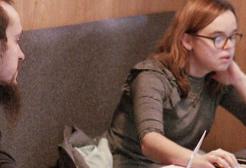 Students studying in a booth in the Library