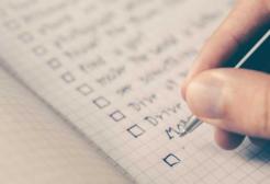 A person writes in a book