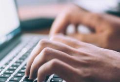 A person typing on a laptop