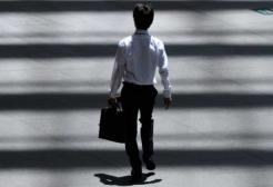 A person walks through shadows