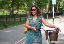 A woman pushing a bike