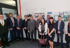 A group photo of India's Deputy High Commissioner and delegation with University of Salford staff.