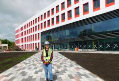 Charlotte France, BSc Building Surveying alumni outside the Science, Engineering & Environment (SEE) Building, University of Salford