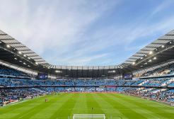 Interior of the Etihad Stadium showing football pitch and terraces